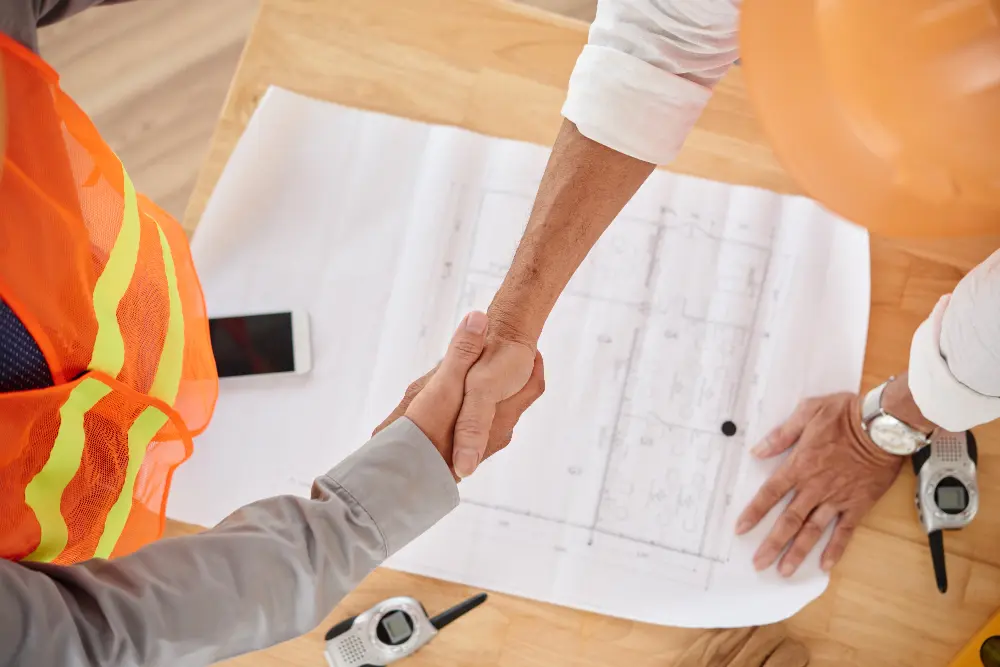 Firm handshake between contractor and client